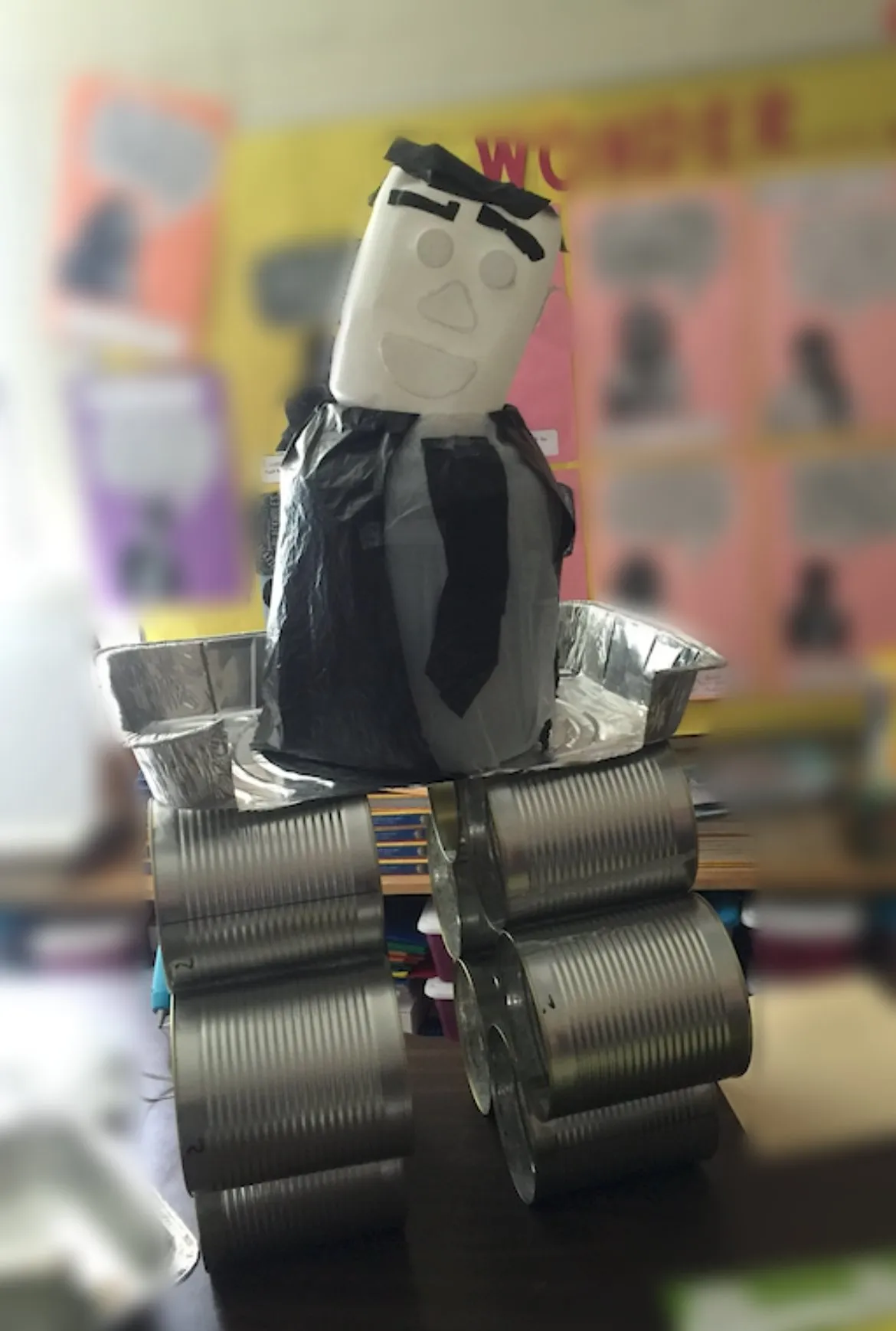 A student-built robot made from tin cans, foil pans, and paper
